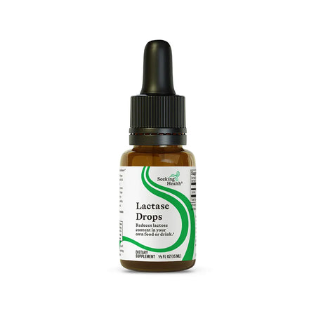 Seeking Health Lactase Drops dietary supplement bottle helps reduce lactose content in food and drinks, 15 ml size.